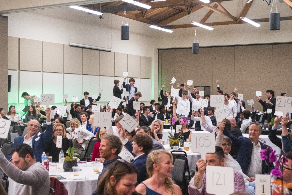 Crowd excitedly bidding