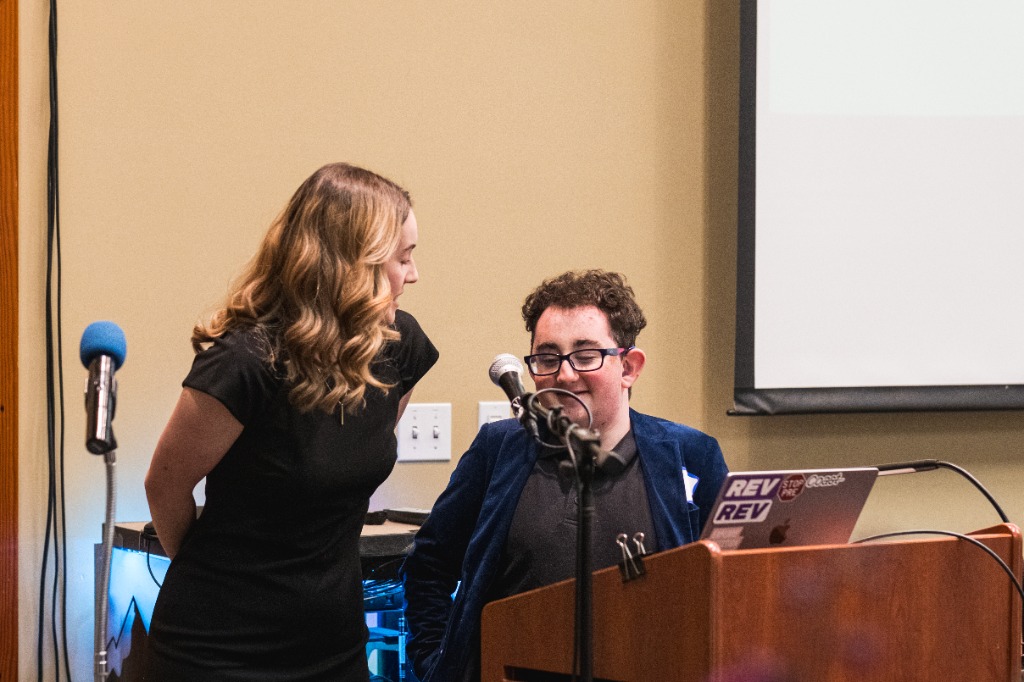 Blake Gettmann speaking at the auction